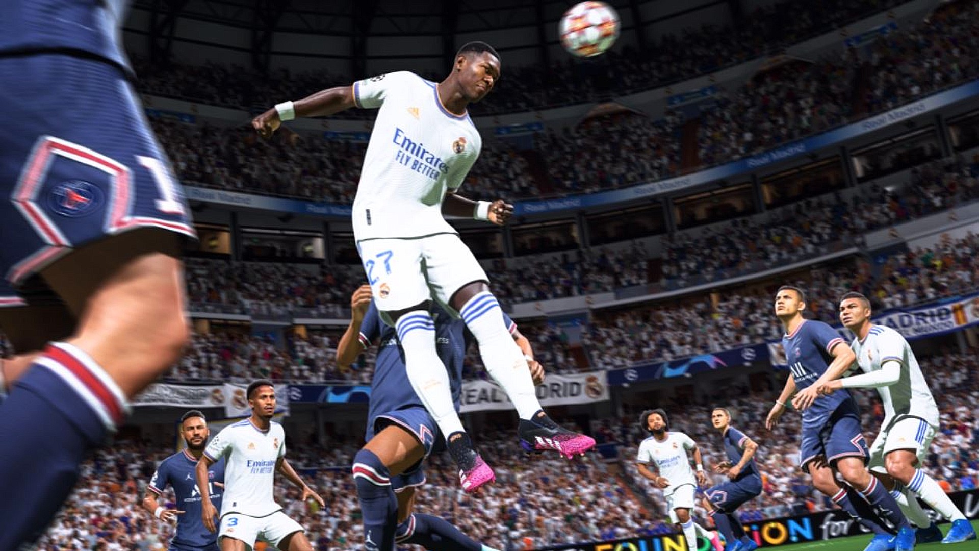 FIFA 22 HyperMotion: A player in white leaping into the air to header the ball.
