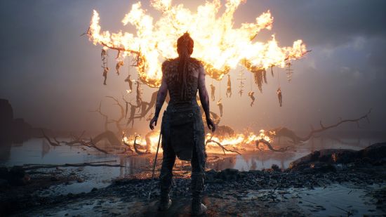 Best games: Senua staring at a burning tree in Hellblade