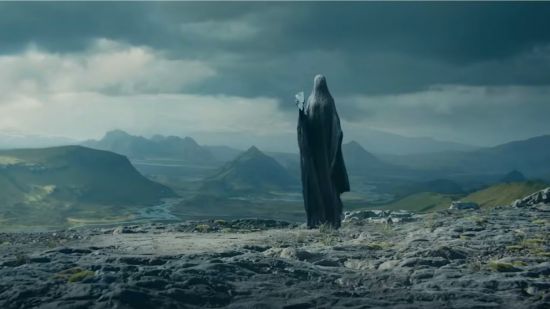 The Final Shape trailer: A person in a full face and body cloak stands in front of some small mountains holding a shard of glass