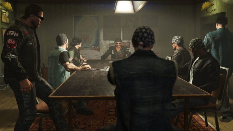Bikers sit round a long table in GTA 5
